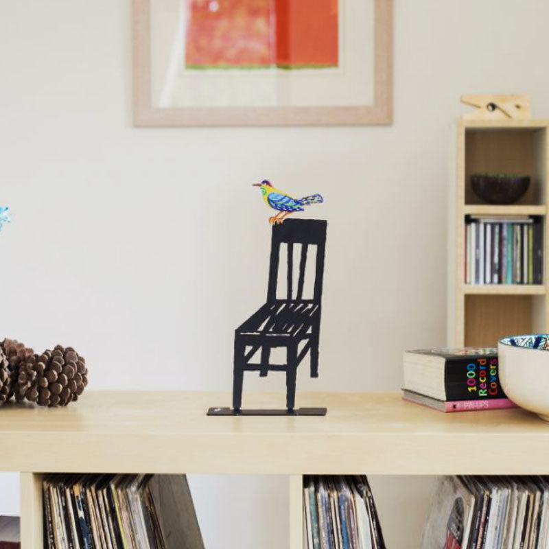 "Bird on an Empty Chair" stand (31*17 cm) made of double-sided colored metal. Designed and produced by artist David Gerstein